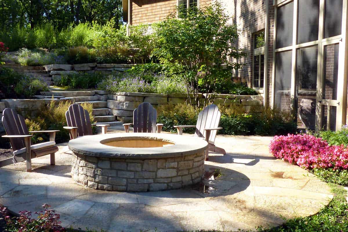 raised stone fire pit on flagstone patio