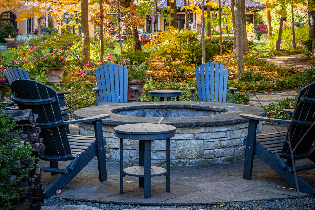 stone firepit with adirondack chairs